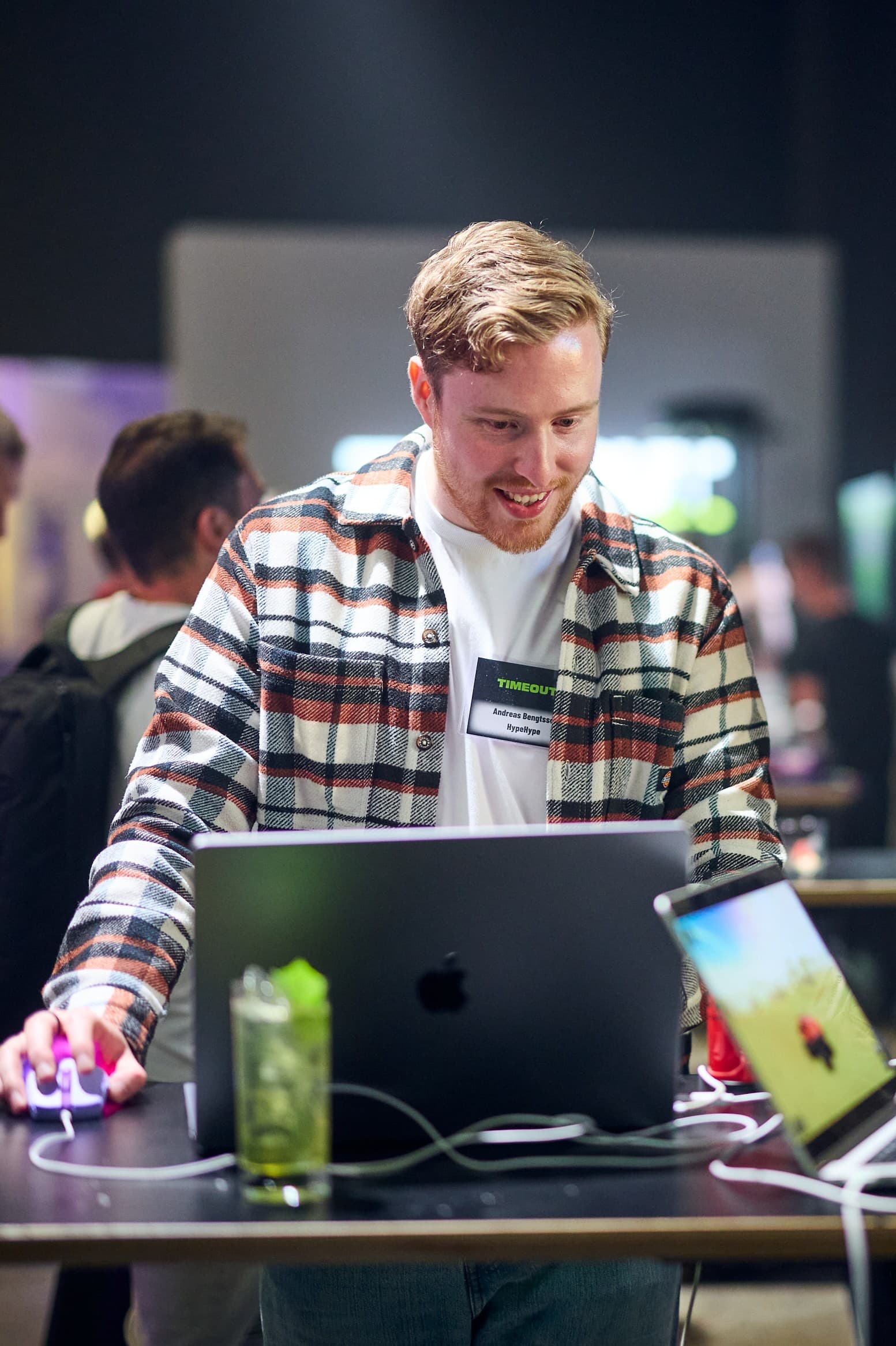 Andreas Bengtsson at a laptop during an event, looking at the screen.